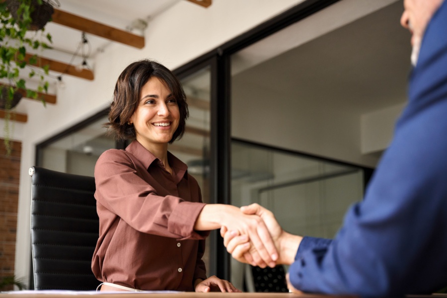 Small business owner shaking hand of customer